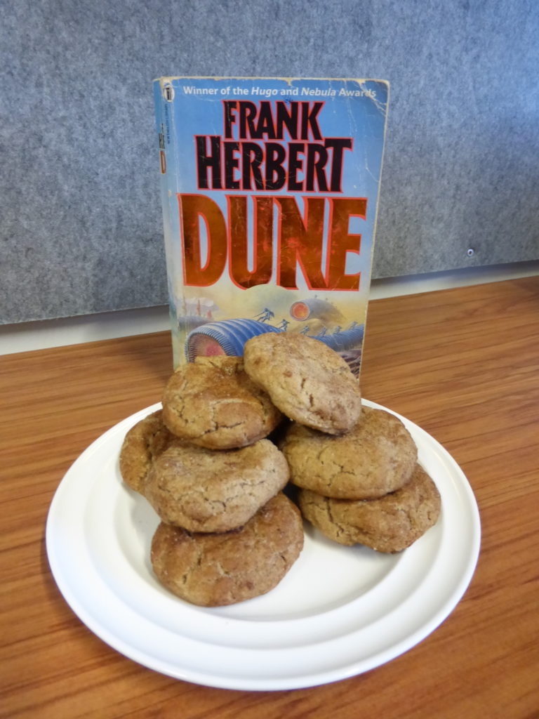 Dune cinnamon spice cookies in front of orange lettered book